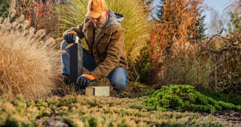 Man Practicing Winter Lawn Care On Wichita Lawn